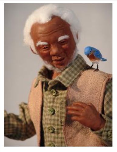 Polymer clay sculpture of an elderly gentleman out for a stroll with a bluebird on his shoulder.